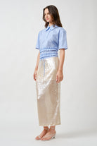 Designed to capture light with effortless grace, this sequin midi skirt is a statement of modern elegance.