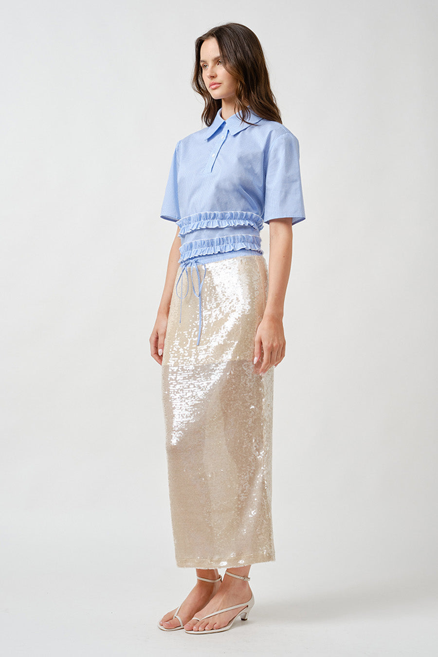 Designed to capture light with effortless grace, this sequin midi skirt is a statement of modern elegance.