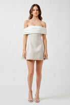 Tailored through the waist, the dress falls into a clean, structured skirt that balances softness with architectural precision.