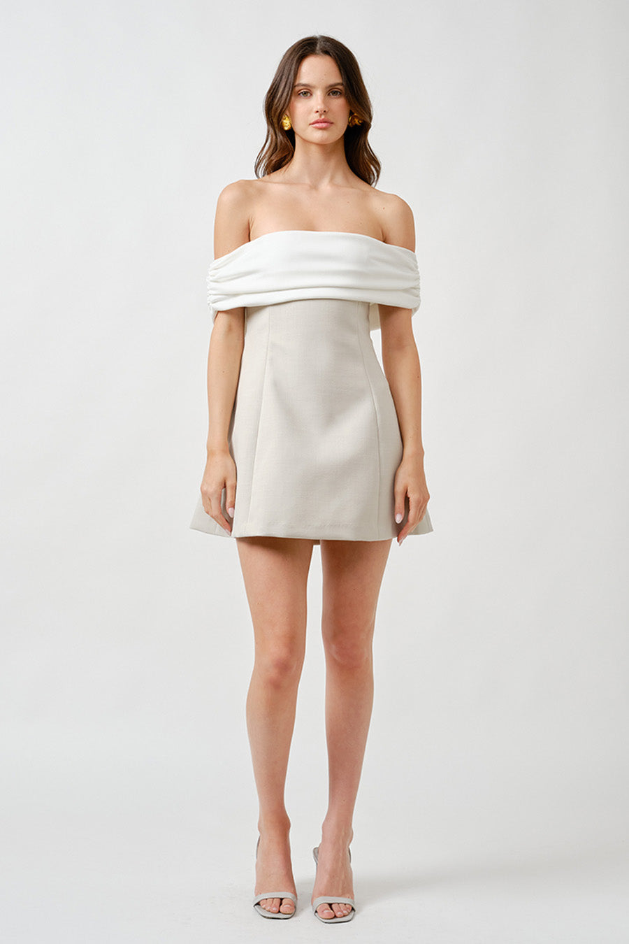 Tailored through the waist, the dress falls into a clean, structured skirt that balances softness with architectural precision.