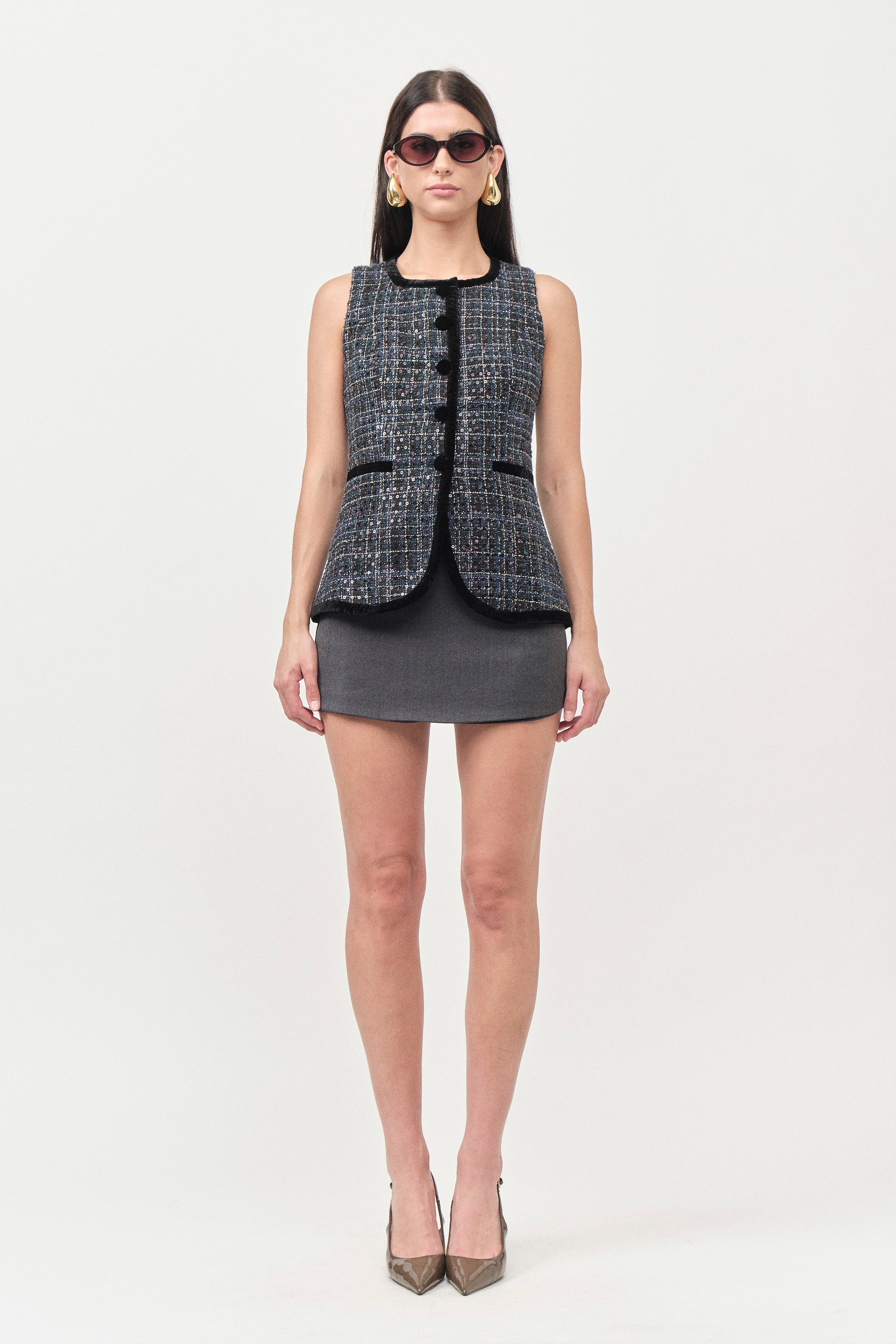 This luxury tweed vest top reimagines classic tailoring through a modern, feminine lens.