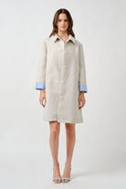 A refined essential for transitional dressing, this ivory coat is designed with understated elegance and modern ease.