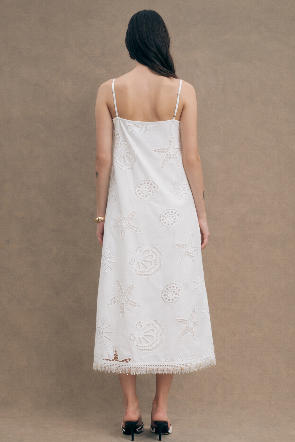  Each dress is hand-embroidered by heritage artisans, with every marine motif individually cut and finished—details that honor the craftsmanship within.