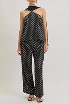 A study in effortless allure, this luxury halter top reimagines timeless polka dots through a modern, architectural silhouette.